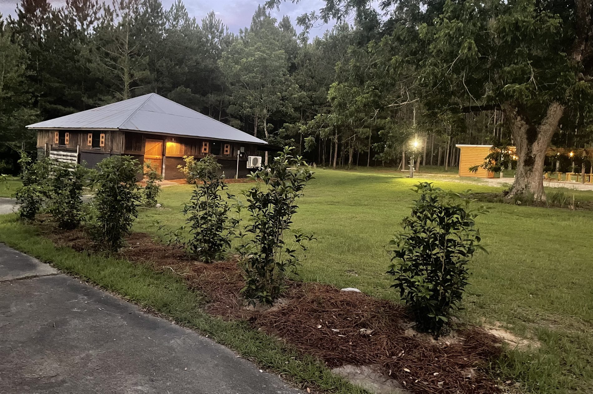 Air conditioned cabin exterior at dusk for retreat stays and bridal suite use