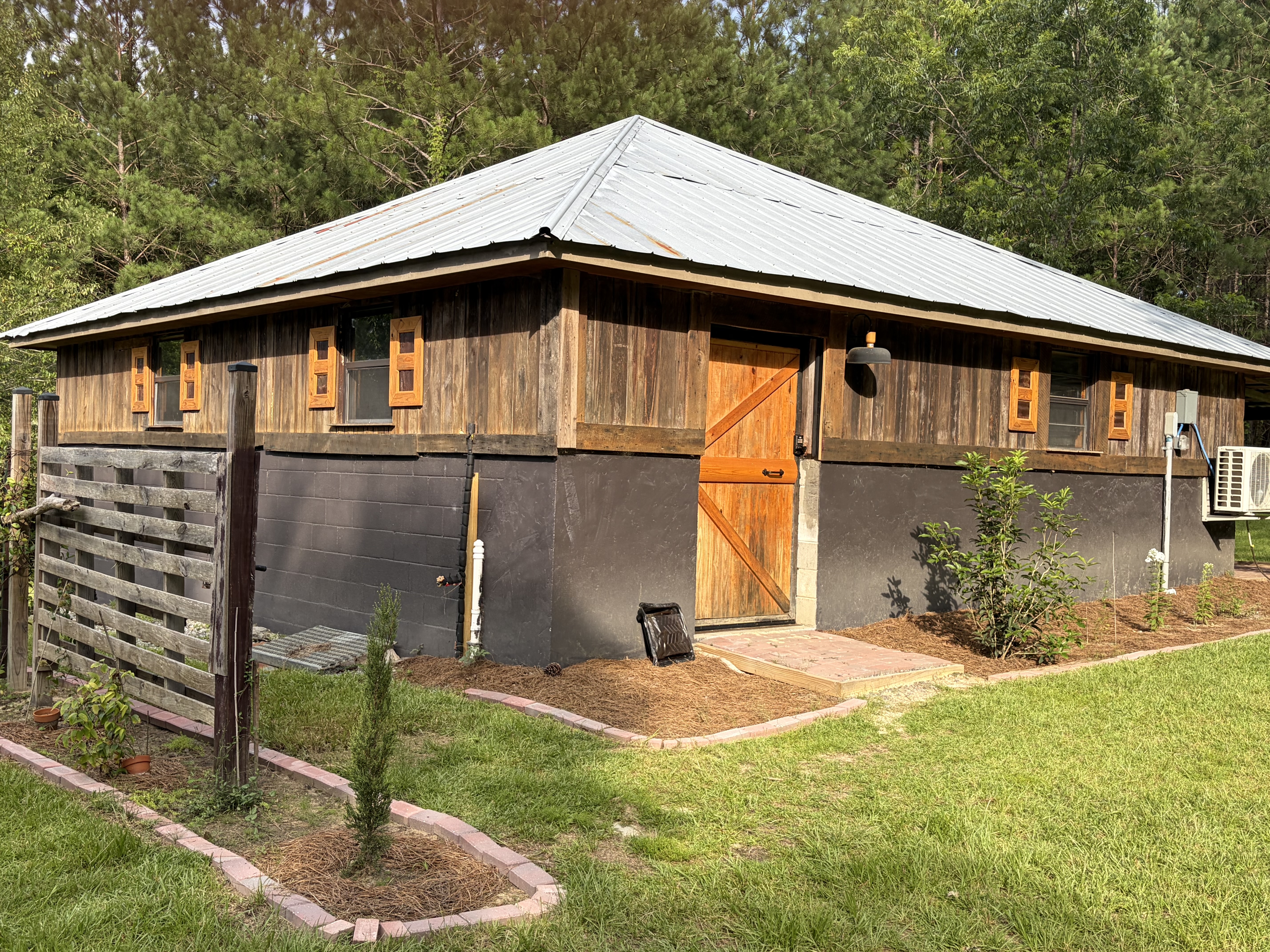 Cabin exterior with rustic fence and warm lights