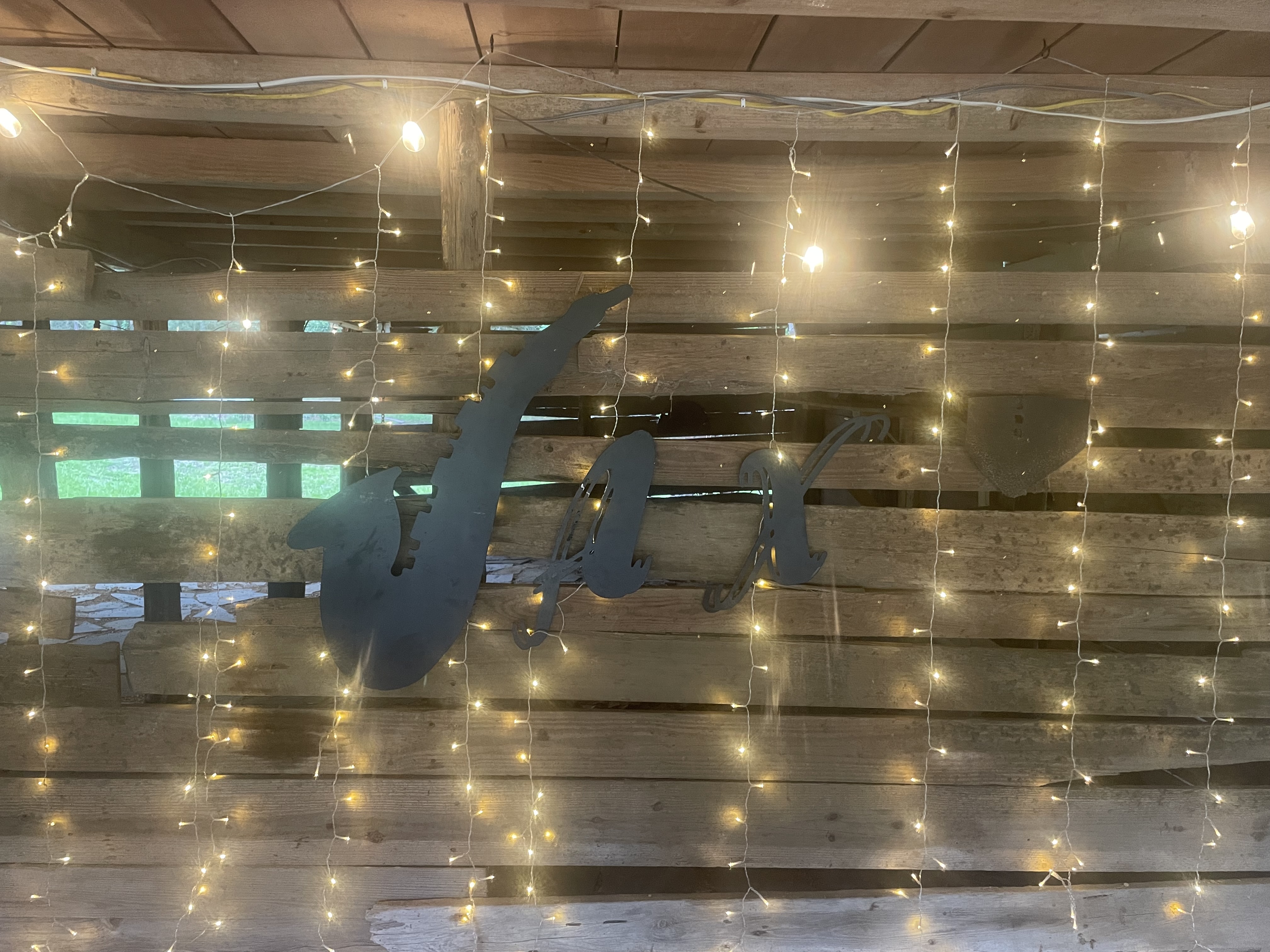 Rustic JaxFarm barn lights and event sign detail